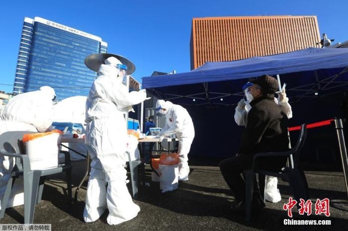 資料圖：韓國首爾，醫(yī)務人員對市民進行新冠病毒檢測。