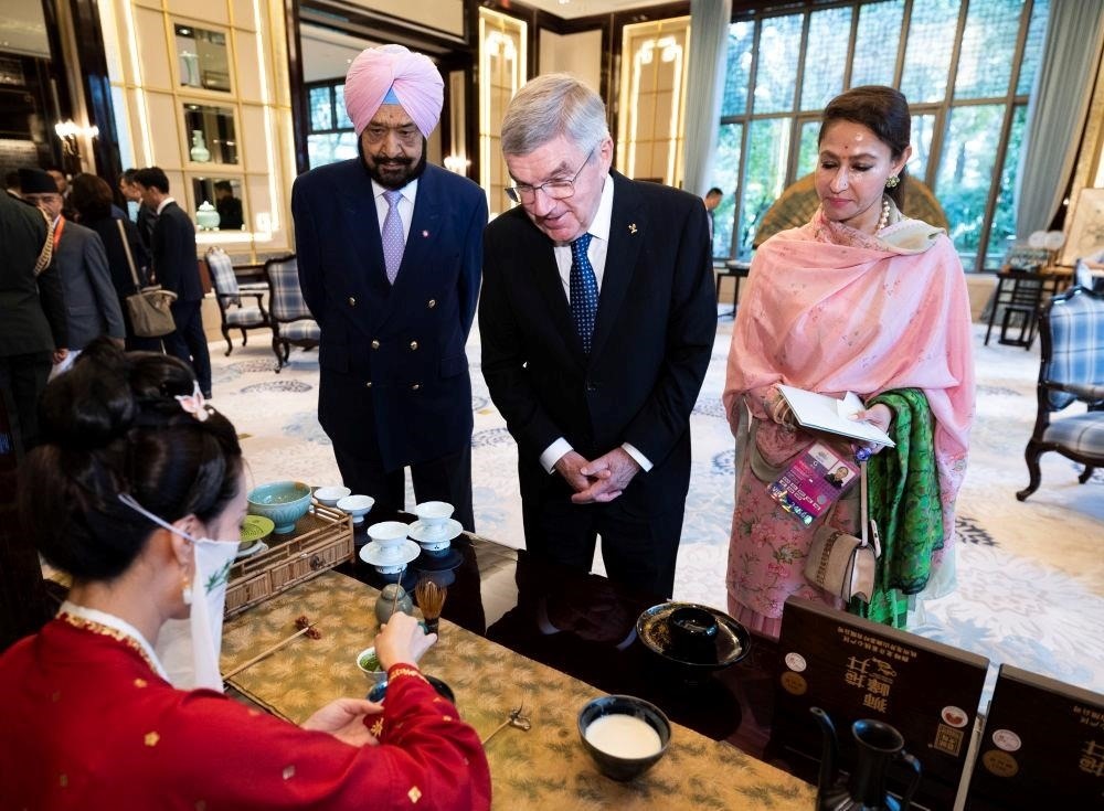 △歡迎宴會前，亞奧理事會代理主席辛格和夫人維尼塔、國際奧委會主席巴赫欣賞非遺展示。