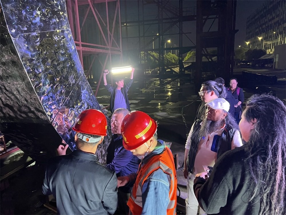 林崗（右二）和團(tuán)隊(duì)查看主火炬制作進(jìn)度。受訪者供圖