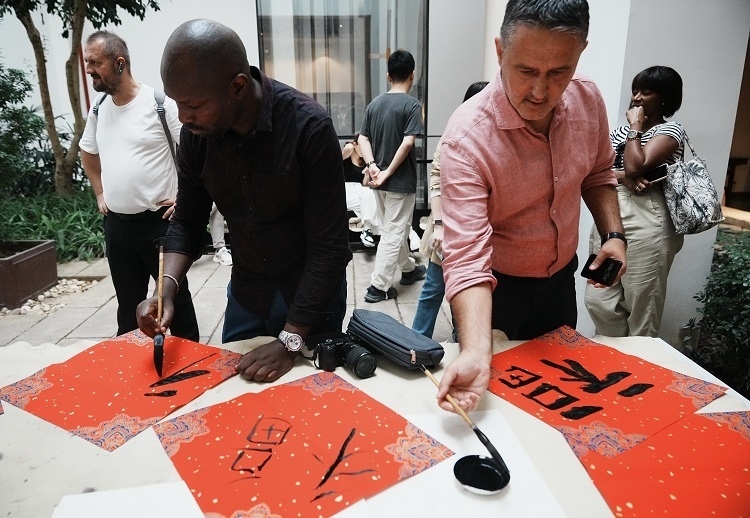 首屆國際傳播“絲路獎”獲獎代表等在廣州市荔灣區(qū)永慶坊參加文化交流活動。楊爍壁、王燕攝影報道