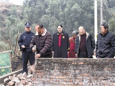  圖③：庭審結(jié)束后，在法官的見證下，陳某在院壩邊重新開鑿一條通道。