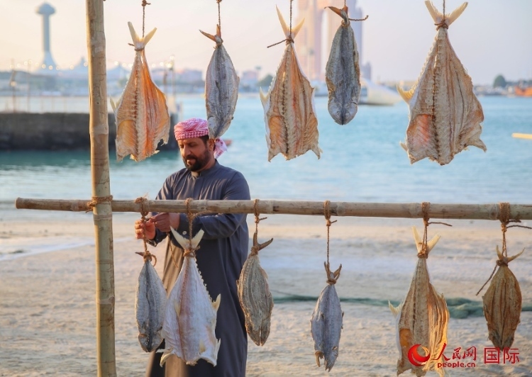  手工藝者展示如何晾曬魚干。人民網(wǎng) 塔里克·易卜拉欣攝