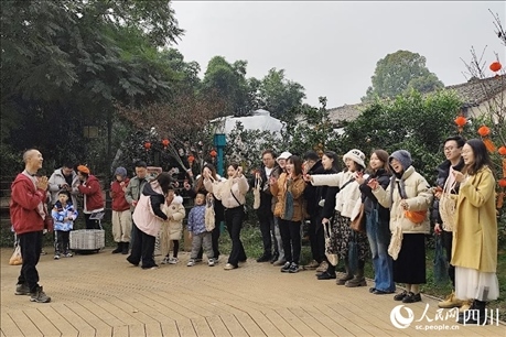 葉科（左一）給前來參與活動的“柑爸柑媽”介紹生態(tài)種植果。人民網(wǎng)記者朱虹攝