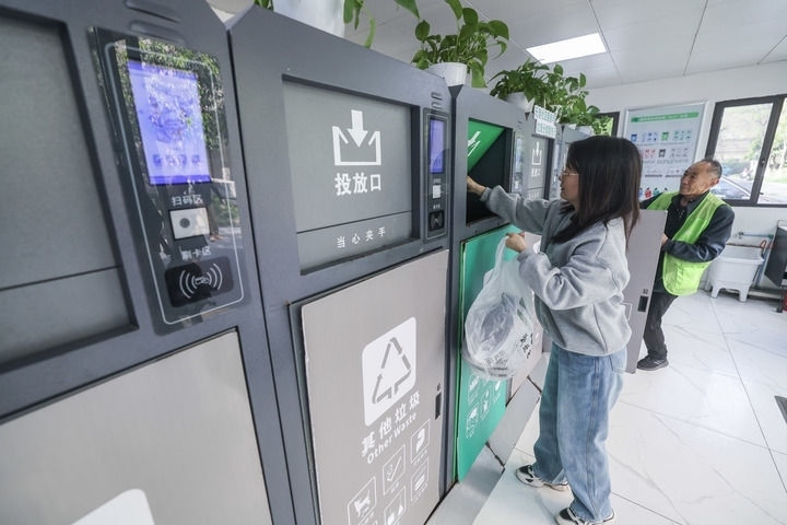 2024年4月10日，在浙江省湖州市吳興區(qū)飛英街道新華府小區(qū)內(nèi)，居民在垃圾分類智能系統(tǒng)的指導(dǎo)下進(jìn)行垃圾分類投放，居民的投放情況將實時匯總到智慧服務(wù)平臺，會有相應(yīng)的積分獎勵。新華社記者 徐昱 攝