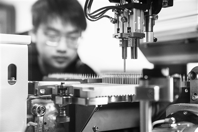 四川某公司，工人正進行微型鉆頭研磨鉆尖工序操作。