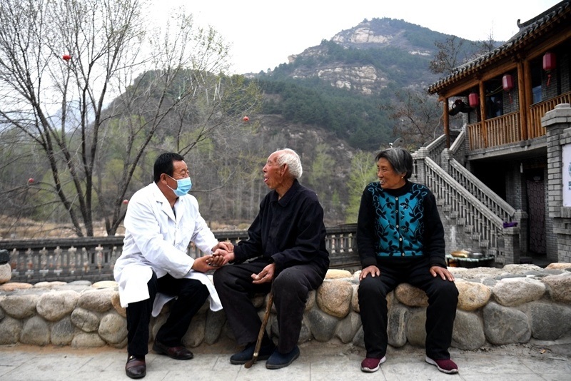 2020年4月15日，在河北阜平縣龍泉關(guān)鎮(zhèn)駱駝灣村，村醫(yī)霍建國(guó)為村民把脈。