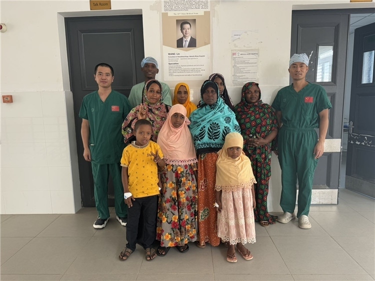 李廣（右一）和王林醫(yī)生與部分患者合影。中國援桑醫(yī)療隊(duì)供圖