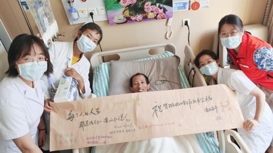 7月26日，海淀醫(yī)院安寧療護(hù)科醫(yī)護(hù)團(tuán)隊(duì)為朱銳送來一條寫滿祝福的橫幅。（受訪者供圖）