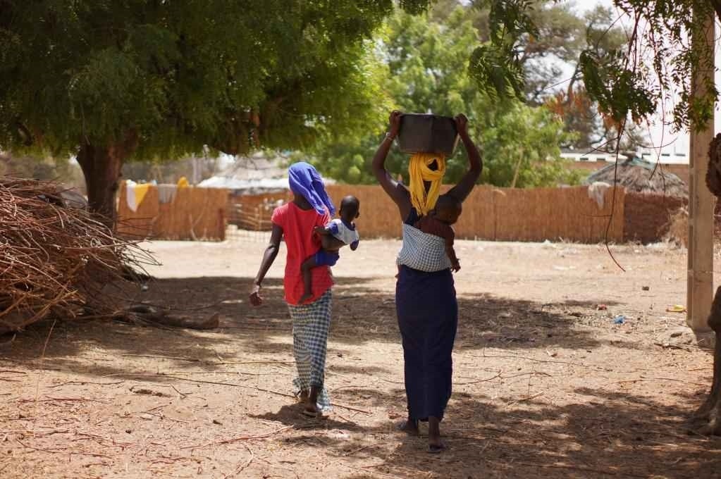 2023年3月20日，在塞內(nèi)加爾久爾貝勒區(qū)的泰內(nèi)富勒村，村民將取到的水運(yùn)回家。新華社記者 王子正 攝