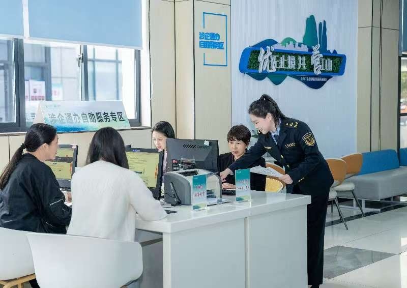 工作人員指導(dǎo)企業(yè)一次性完成信息填報(bào)。圖片來源：浙江衢州市市場監(jiān)督管理局