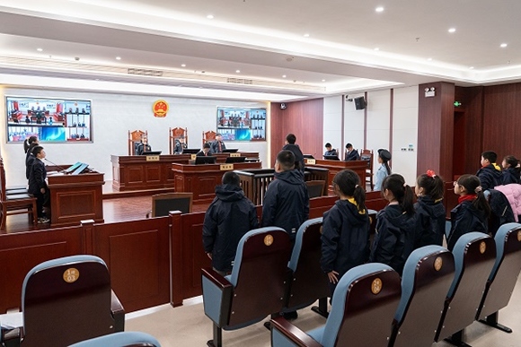 圖③：同學(xué)們開(kāi)展模擬法庭活動(dòng)。