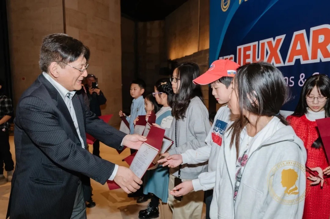 圖2：亞丁為獲獎(jiǎng)兒童頒發(fā)證書。法中交流促進(jìn)會(huì)供圖